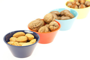 nuts in bowls isolated on white