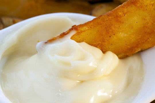 Close Up Fried Potato Dipped in Garlic Mayonnaise