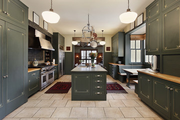 Large kitchen with green cabinetry