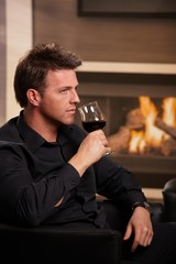 Man tasting wine at home