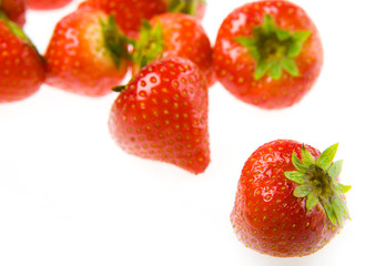 Group of fresh isolated strawberries on a white background