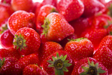 Bunch of fresh strawberries lying on a white background