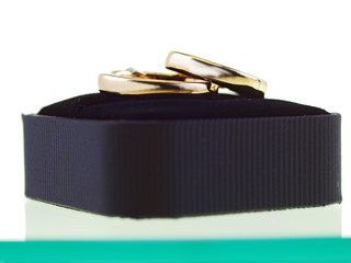 two gold rings in a black box
