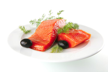 pink smoked salmon on white plate with olives