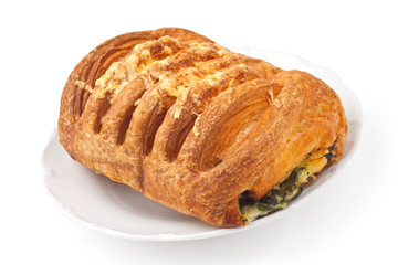 Bun with cheese and spinach on a plate