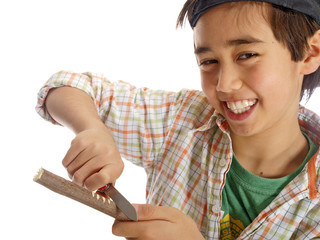 child carving a wooden stick