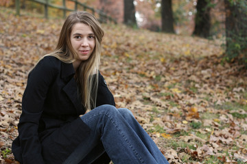 Girl sitting on leaves