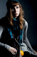 beautiful girl with scarf and hat and oranges