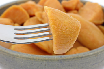 Yam on fork with full dish in background