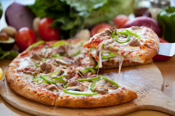 Supreme Pizza lifted slice 4