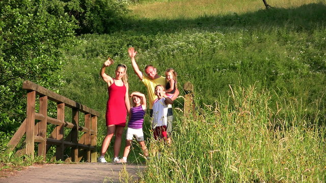 Family with Children on bridge waving