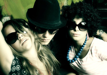 Fashion young guys and girls sitting together and having fun