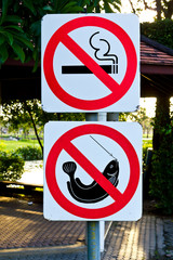 no smoking and no fishing warning sign in the park