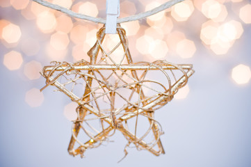 Christmas star ornament with golden bokeh background