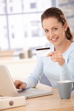 Young woman shopping on internet smiling