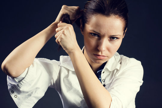 Angry young woman pulling her hair