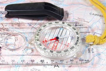 whistle and compass on map