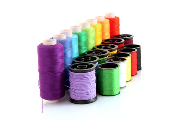 Coloured bobbins of thread isolated on white