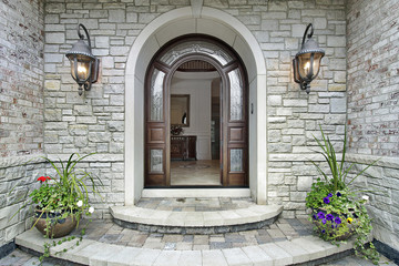 Fototapeta na wymiar Arched stone entry to luxury home