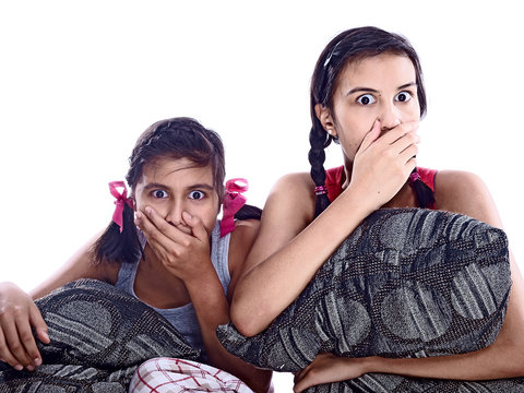 shocked girls covering mouth with hands isolated on white