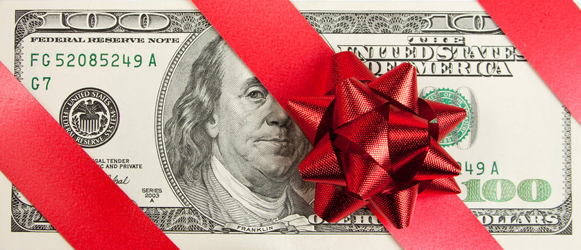 One hundred bill with red bow and ribbon