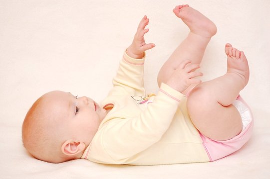 Cute baby playing with feet