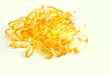 pile of shiny yellow capsule vitamin e isolated