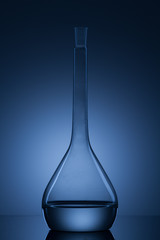 flask with liquid and blue background