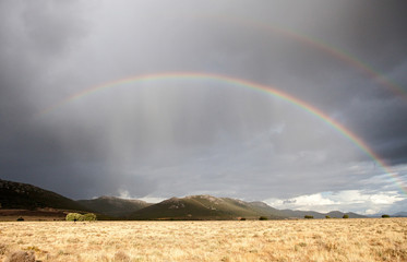 Fototapeta na wymiar Dark sky with a rainbow