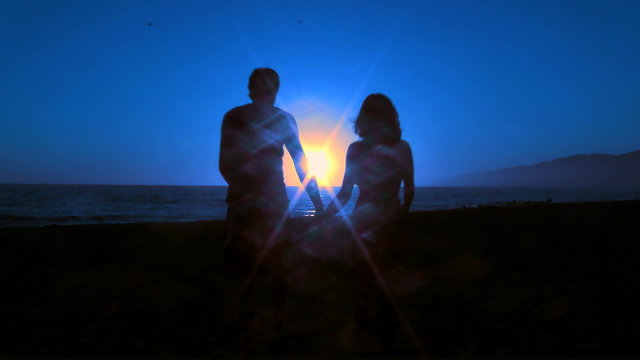 Couple on honeymoon walks into sunset - HD
