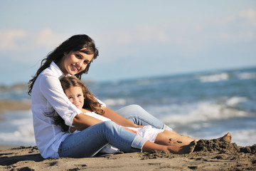 Naklejka na ściany i meble mom and daughter portrait on beach
