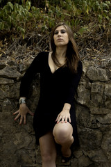 beautiful woman next to a wall