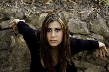 beautiful woman next to a wall