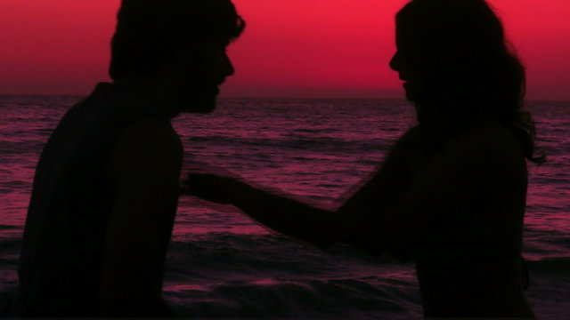 Romantic couple kisses on beach at sunset - HD
