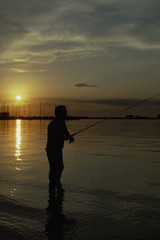 man fishing at sunset