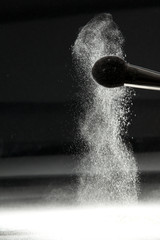 detail of a powder brush with white loose powder