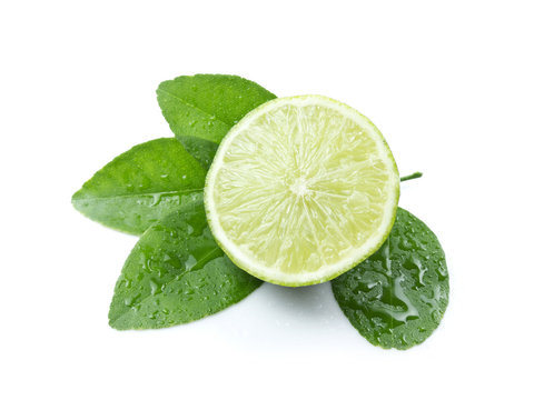 Green lemon with leaves on white