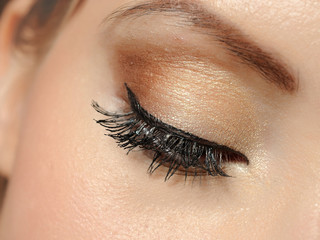Beautiful macro shot of eye with long lashes and make-up in brow - 27615486