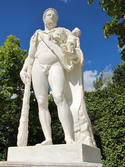 A man with bludgeon to hold a baby statue