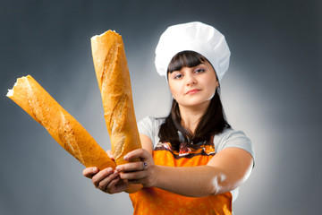 woman cook holding french bread, focus on the bread