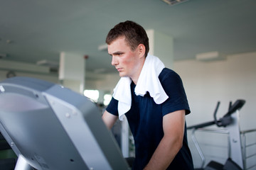 Healthy man a treadmill in a sport center