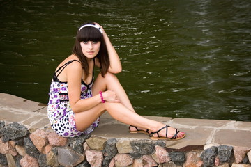 Woman sitting near the water