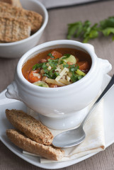 Bacon, bean and pasta soup in a bowl