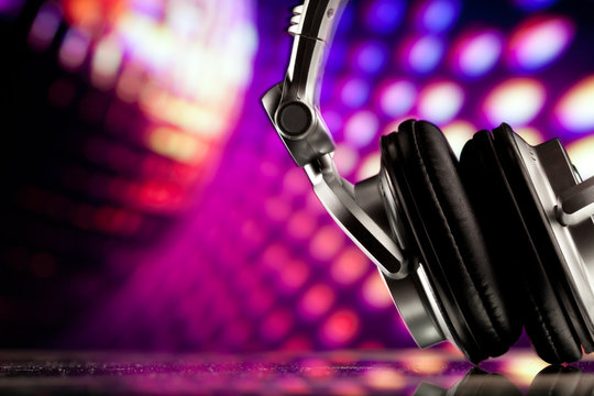 headphones against purple disco background