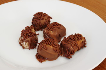 Luscious chocolate pralines on a plate.