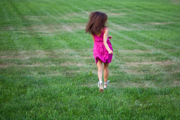 Beautiful young woman running on the field