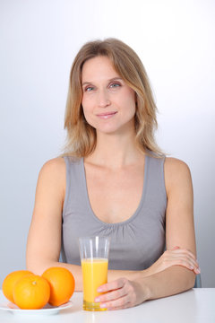 Woman drinking fresh orange juice