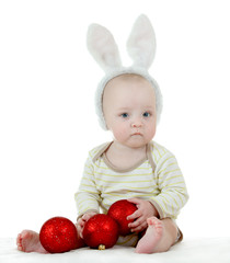 Little child in bunny ears holding new year balls