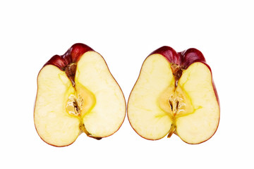Red apple cut in two halfs isolated over white background.