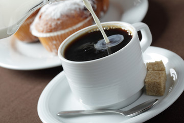 Pouring milk into coffee
